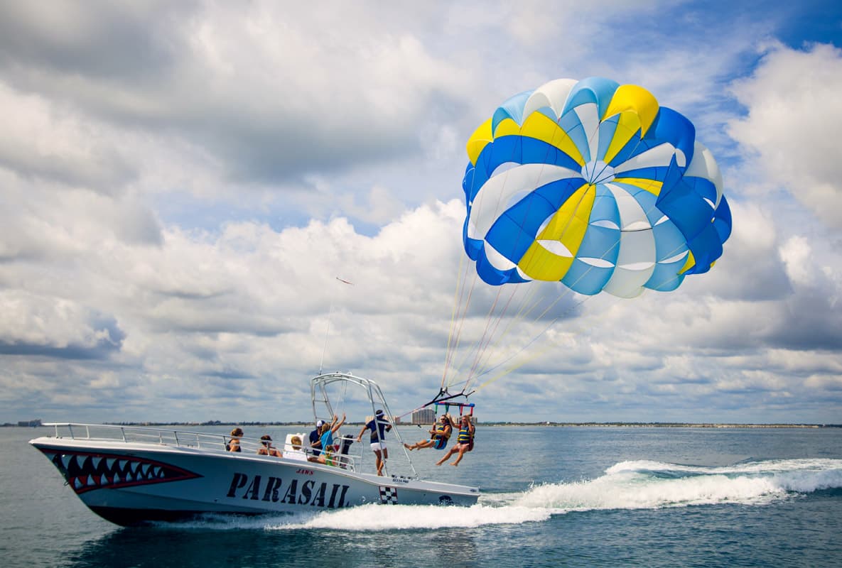 Guests being lifted off the boat at the start of a parasail flight.